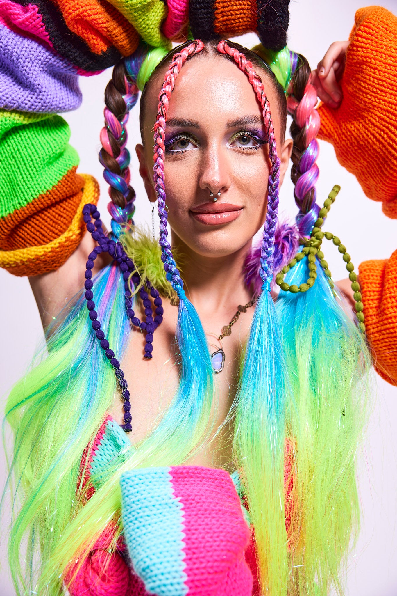 Woman wearing Funhouse - UV Rainbow Ombre Tinsel Braiding Hair