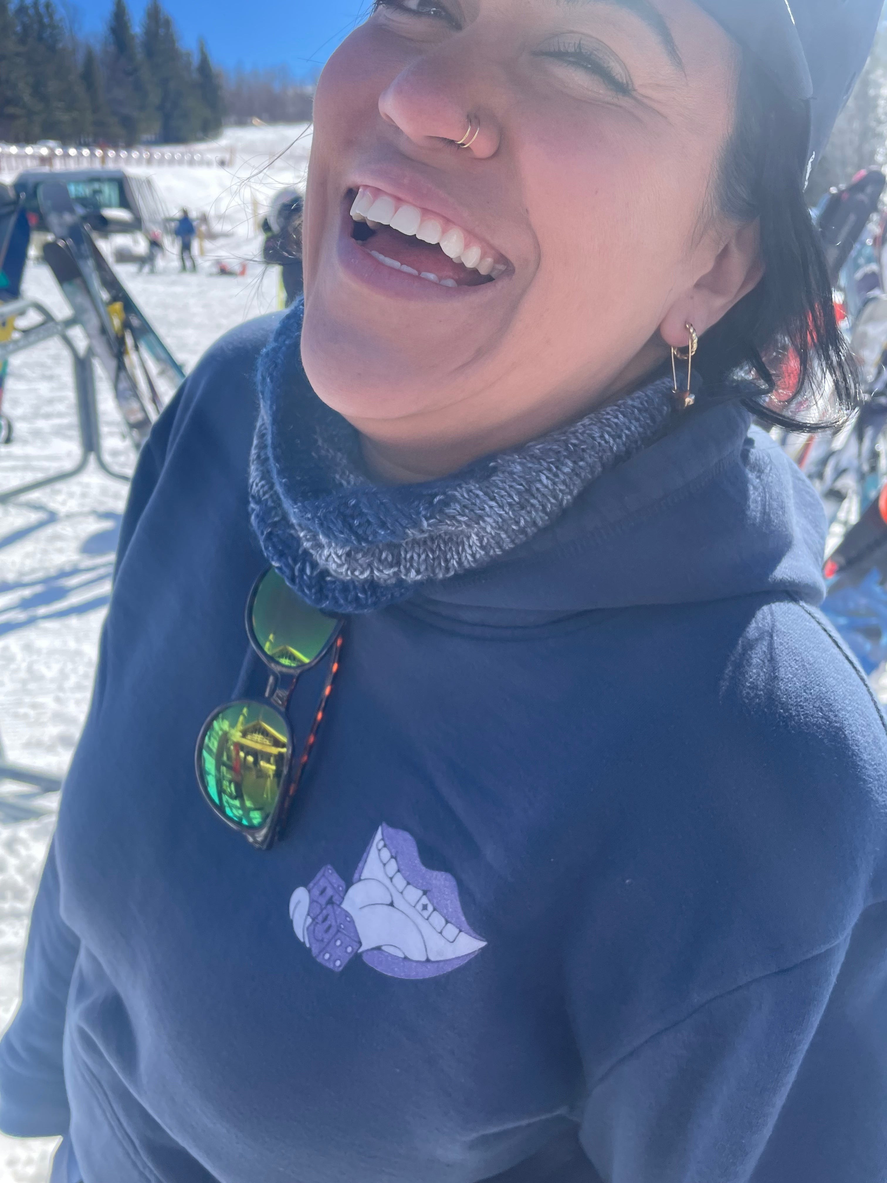 Woman at ski resort with Half Sweet logo on hoodie